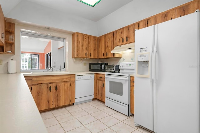 kitchen featuring sink, light tile patterned floors, and white appliances