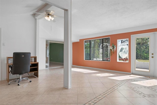 interior space featuring ceiling fan, light tile patterned floors, and lofted ceiling with beams