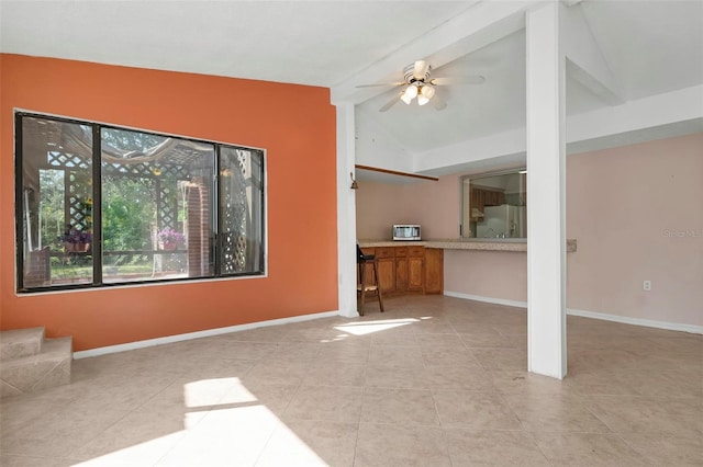 unfurnished living room with vaulted ceiling with beams, ceiling fan, and light tile patterned floors