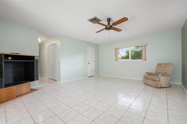 unfurnished living room with light tile patterned floors and ceiling fan