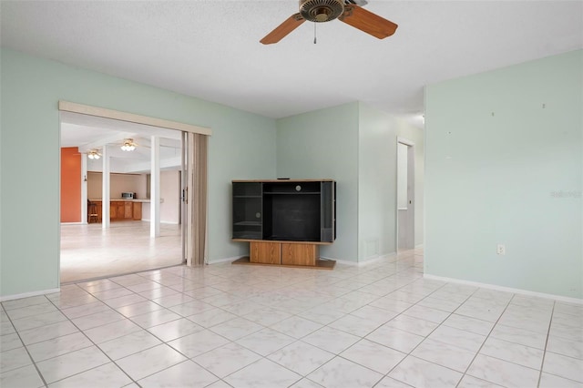 unfurnished living room featuring ceiling fan and light tile patterned floors