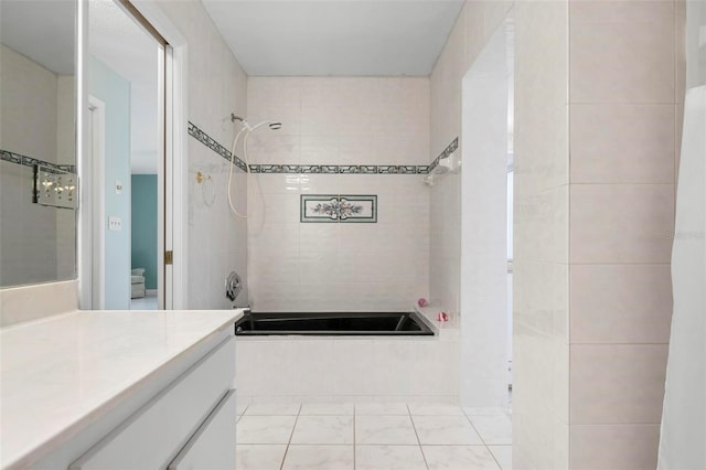 bathroom with vanity and tiled shower / bath combo