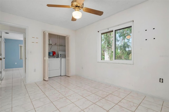 tiled spare room featuring ceiling fan and washer and clothes dryer