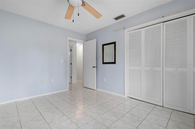 unfurnished bedroom featuring ceiling fan, a closet, and light tile patterned floors