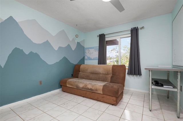 living area with ceiling fan and a textured ceiling