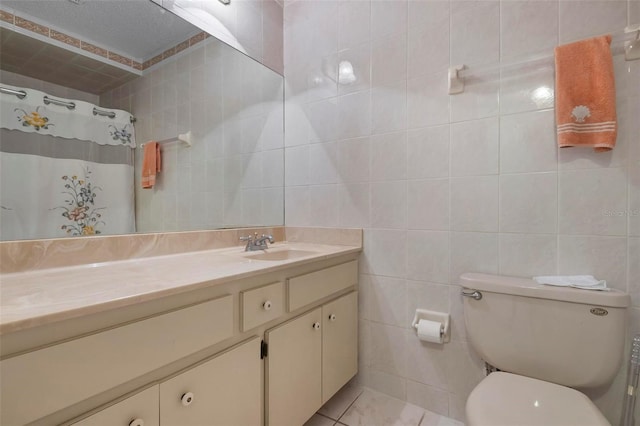 bathroom with walk in shower, vanity, tile walls, tile patterned flooring, and toilet