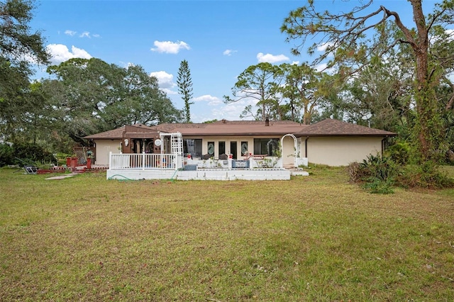 back of house with a lawn