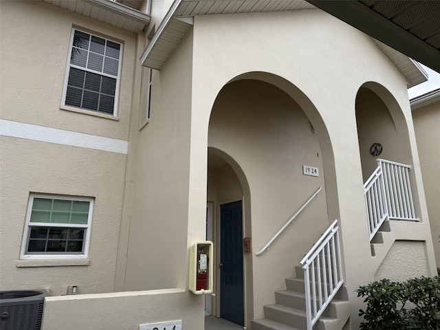 doorway to property featuring central air condition unit