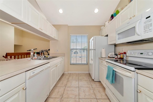 kitchen with white cabinets, light tile patterned floors, white appliances, and sink