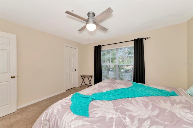 bedroom with ceiling fan and light colored carpet