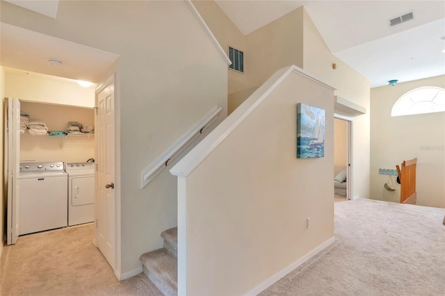 stairs with carpet flooring and independent washer and dryer