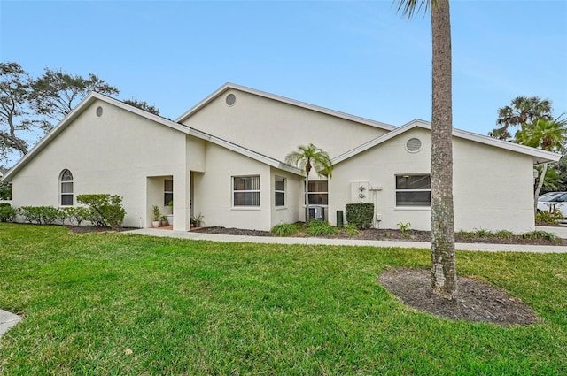 rear view of property featuring a lawn