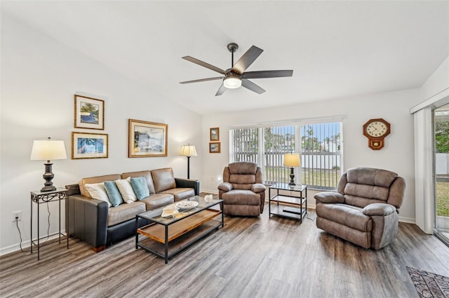 living room featuring ceiling fan, wood-type flooring, and lofted ceiling