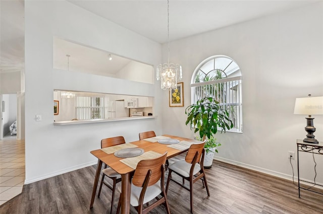 dining area with a chandelier and hardwood / wood-style flooring