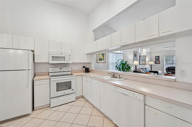 kitchen with ceiling fan, sink, light tile patterned floors, white appliances, and white cabinets