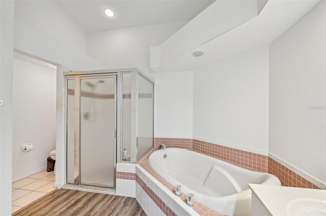 full bathroom with toilet, vanity, and shower with separate bathtub