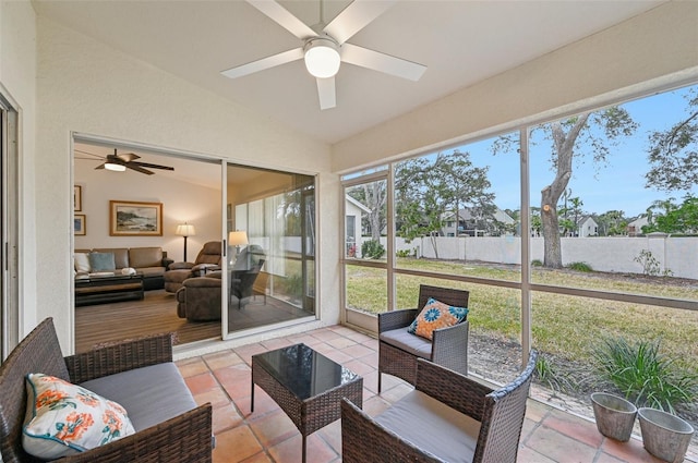 sunroom featuring ceiling fan and lofted ceiling