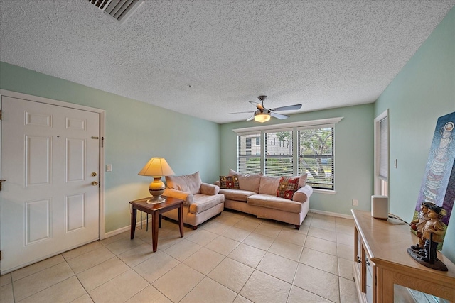 tiled living room with ceiling fan and a textured ceiling