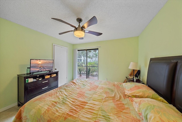 bedroom featuring ceiling fan, access to exterior, a textured ceiling, and tile patterned floors