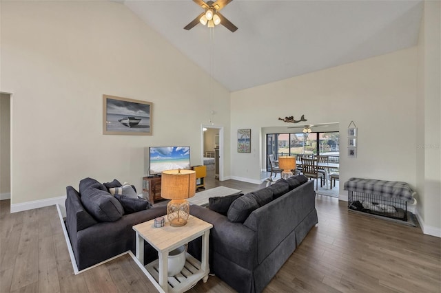 living room featuring ceiling fan, hardwood / wood-style floors, and high vaulted ceiling