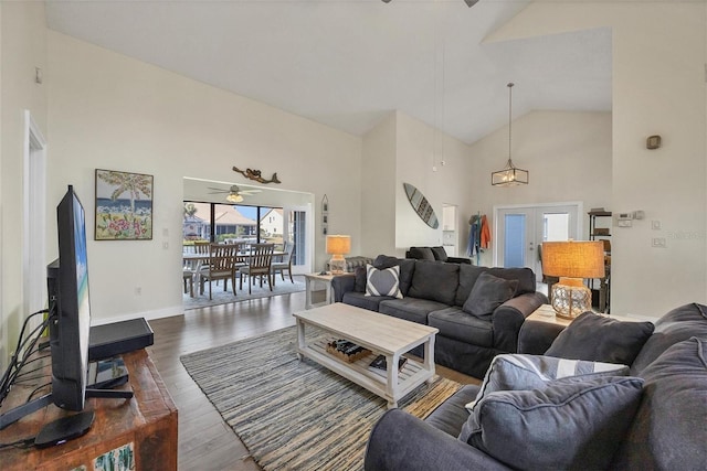 living room with lofted ceiling, ceiling fan, dark hardwood / wood-style flooring, and french doors