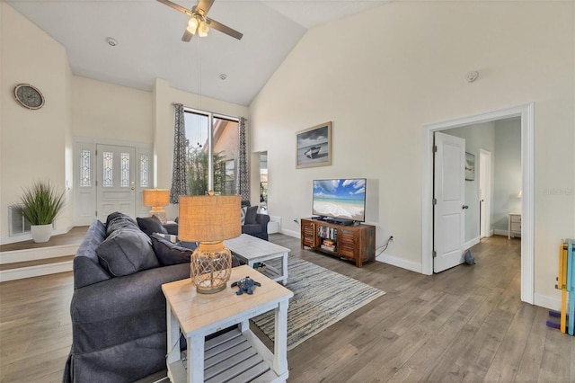 living room featuring hardwood / wood-style flooring, ceiling fan, and high vaulted ceiling