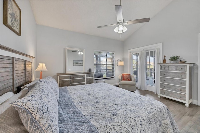 bedroom featuring access to outside, vaulted ceiling, ceiling fan, and hardwood / wood-style flooring