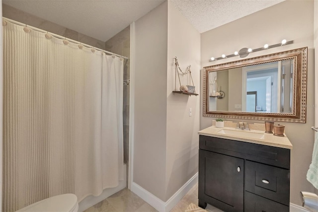 bathroom with tile patterned flooring, vanity, toilet, and a textured ceiling