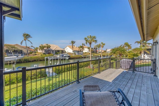 deck with a lawn and a water view