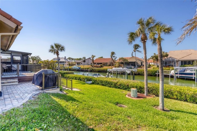 view of yard featuring a water view and a sunroom