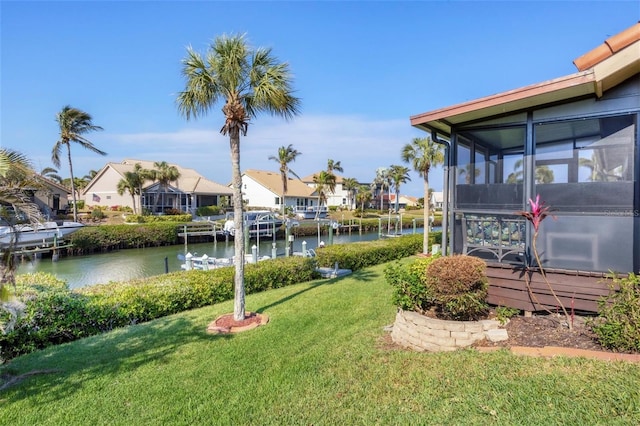 view of yard with a water view and a sunroom