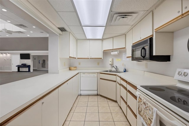 kitchen with white cabinetry, sink, and white appliances