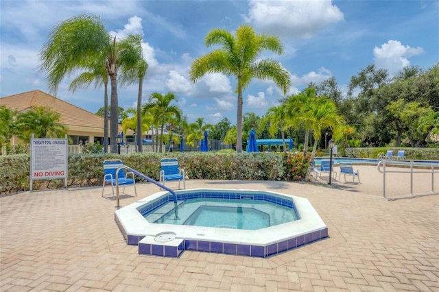 view of pool featuring a hot tub