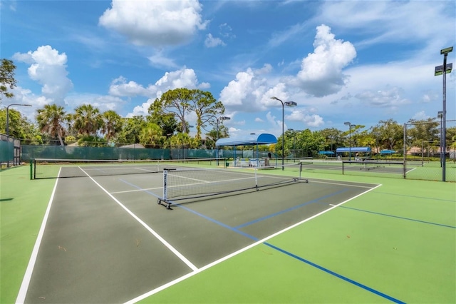 view of tennis court featuring basketball hoop