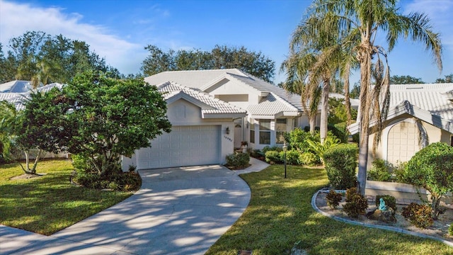 view of front of property featuring a front yard and a garage