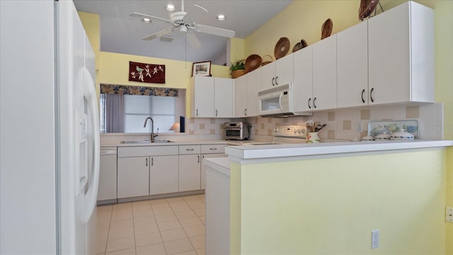 kitchen with white cabinets, white appliances, and sink