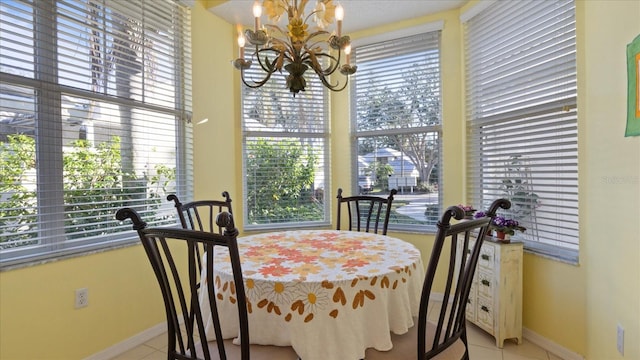 tiled dining space with a chandelier