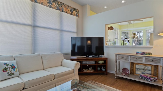 living room featuring hardwood / wood-style floors and a notable chandelier