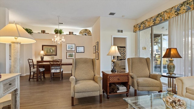 living area featuring dark wood-type flooring and a notable chandelier