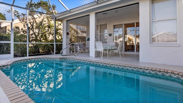 view of pool with a patio and a lanai