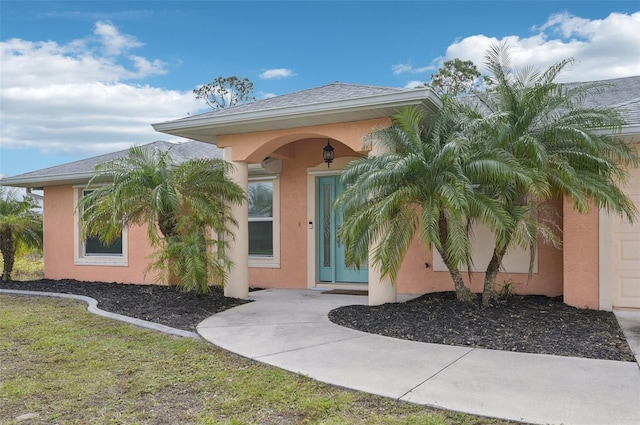 entrance to property with a lawn