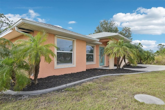 view of side of home with a lawn