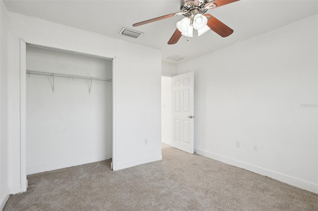 unfurnished bedroom featuring carpet floors, a closet, and ceiling fan