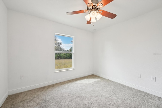 empty room featuring ceiling fan and carpet floors