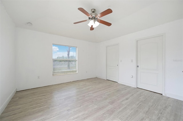 unfurnished bedroom with ceiling fan and light hardwood / wood-style flooring