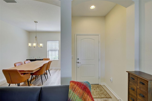 foyer featuring a chandelier and light hardwood / wood-style floors