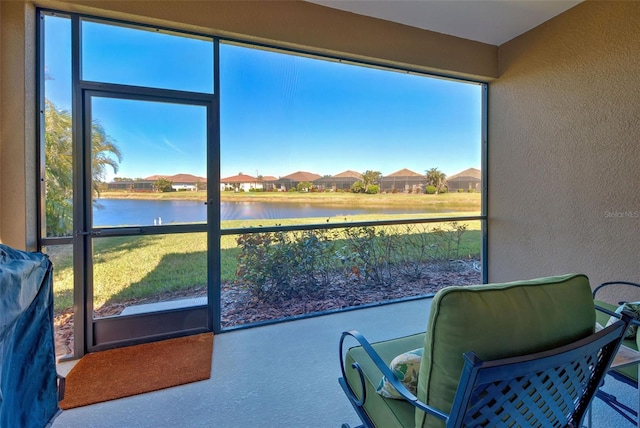sunroom / solarium with a water view