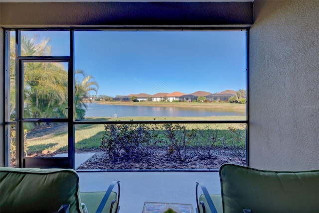 unfurnished sunroom featuring a water view and a wealth of natural light