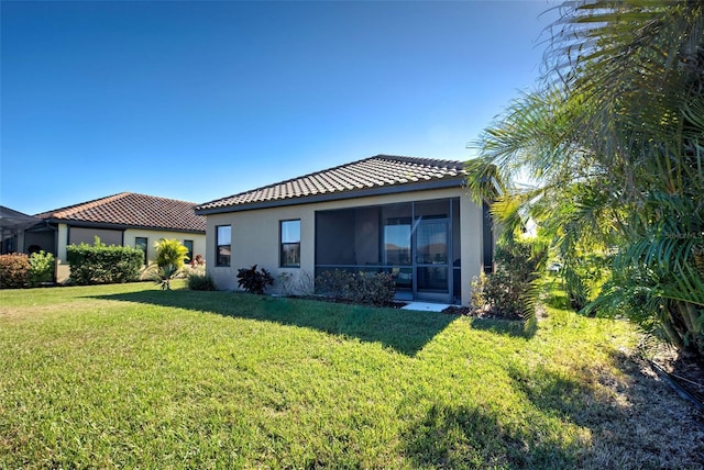 rear view of property with a yard