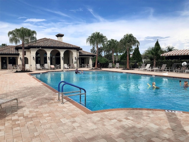 view of swimming pool with a patio